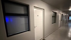 A hallway with a door marked '11', a window, and a door with a frosted glass panel. - Stylish Stay at 11 on Arch in Langebaan, South Africa (Langebaan)