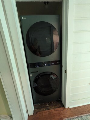 A laundry room with an LG washer and dryer, a circular mirror, and a small rug on the floor. - Georgetown cottage  cozy, updated 2 bedroom 3 blocks from historic downtown (Georgetown)