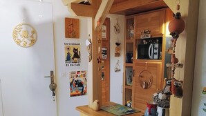 Une cuisine en bois avec un comptoir en bois, une pancarte « Bienvenue » et divers ustensiles de cuisine.