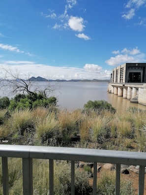 A view of a body of water with a bridge and a building with a flat roof.