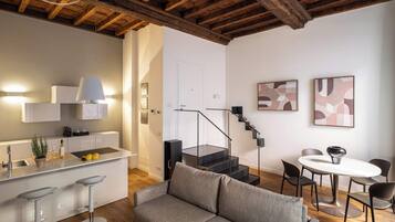 Apartment (Milano Cairoli) | Living area | 40-inch flat-screen TV with digital channels, heated floors