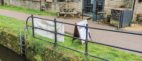 A riverside building with a sign for 'Northern Sole Kitchen & Common Room.'