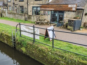 A riverside building with a sign for 'Northern Sole Kitchen & Common Room.' - No.1 Spa Mill Lodge (Huddersfield)