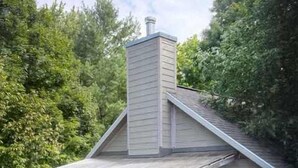 A house with a covered porch, a chimney, and a deck. - The Artist's Loft | Pet Friendly | Close to Torch (Alden)