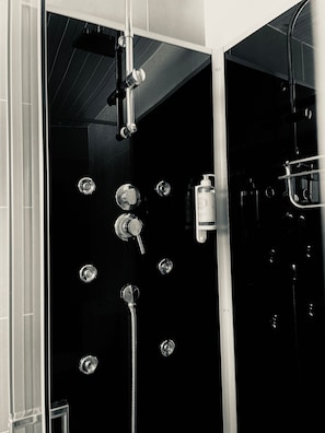 A bathroom with a shower, a toilet, and a sink.