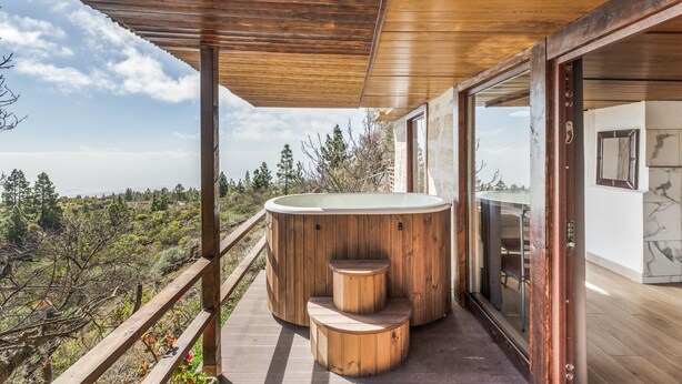 A wooden deck with a hot tub, wooden steps, and a glass door leading to a room with a marble wall. - Vacation Home 'Karla' with Sea View, Shared Pool and Wi-Fi (Cruz de Tea)