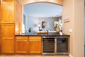 A kitchen with wooden cabinets, a black countertop, and a built-in oven. - Luxury Power Ranch Estate- Pool, Spa & Golf Green (Gilbert)