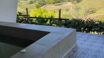 A pool area with a view of a hilly landscape.