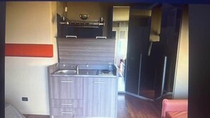 A compact kitchen with a sink, cabinets, and a countertop. - CARLOTTA STATION SUITE (Bologna)