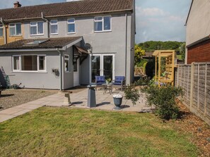 A residential house with a patio, outdoor seating, and a garden. - Onny Views (Craven Arms)