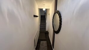 A narrow hallway with a staircase leading to a landing. - Modern 2BR Belfast Stay | Sleeps 4 | Free Parking (Belfast)