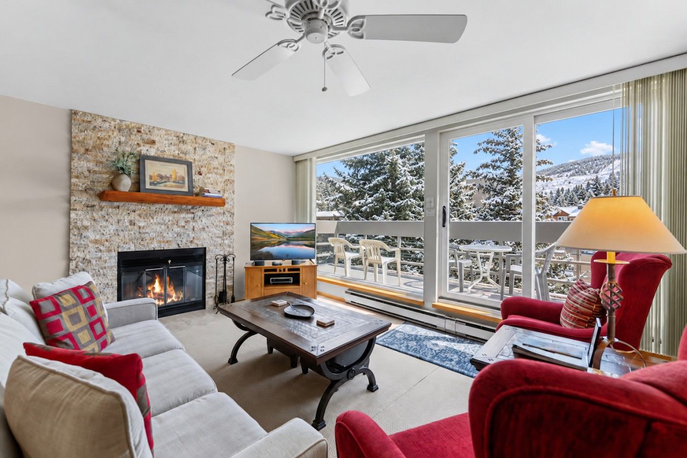 Sun drenched living room with smart TV and fireplace