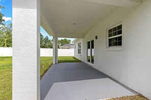 A covered porch with a concrete floor, white walls, and a window. - Horse Country Escape 15 Minutes to WEC & Adventure Springs (Lutz)