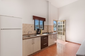A kitchen with a refrigerator, sink, stove, and cabinets. - Vacation Home 'Jomeca 2' with Mountain View, Shared Pool and Wi-Fi (San Bartolomé de Tirajana)