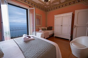 A hotel room with a balcony, a bed, a wardrobe, and a chair. - [Gulf Villa] Incredible View • Art • Relax (Laigueglia)