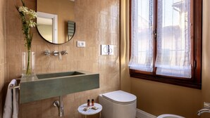 A bathroom with a large sink, toilet, and bathtub. - Geometric Design Suite by Maison Florence (Florence)