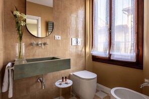 A bathroom with a large sink, toilet, and bathtub. - Geometric Design Suite by Maison Florence (Florence)