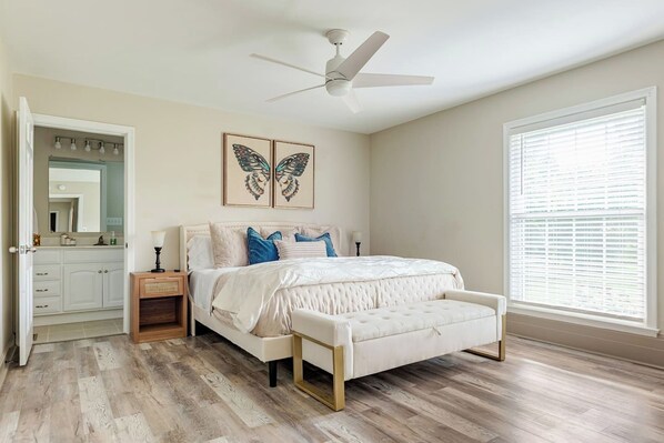 A bedroom with a bed, bedside table, nightstand, and a window with blinds. - Welcome to Skyline Point ~ Louisville Skyline (Floyds Knobs)