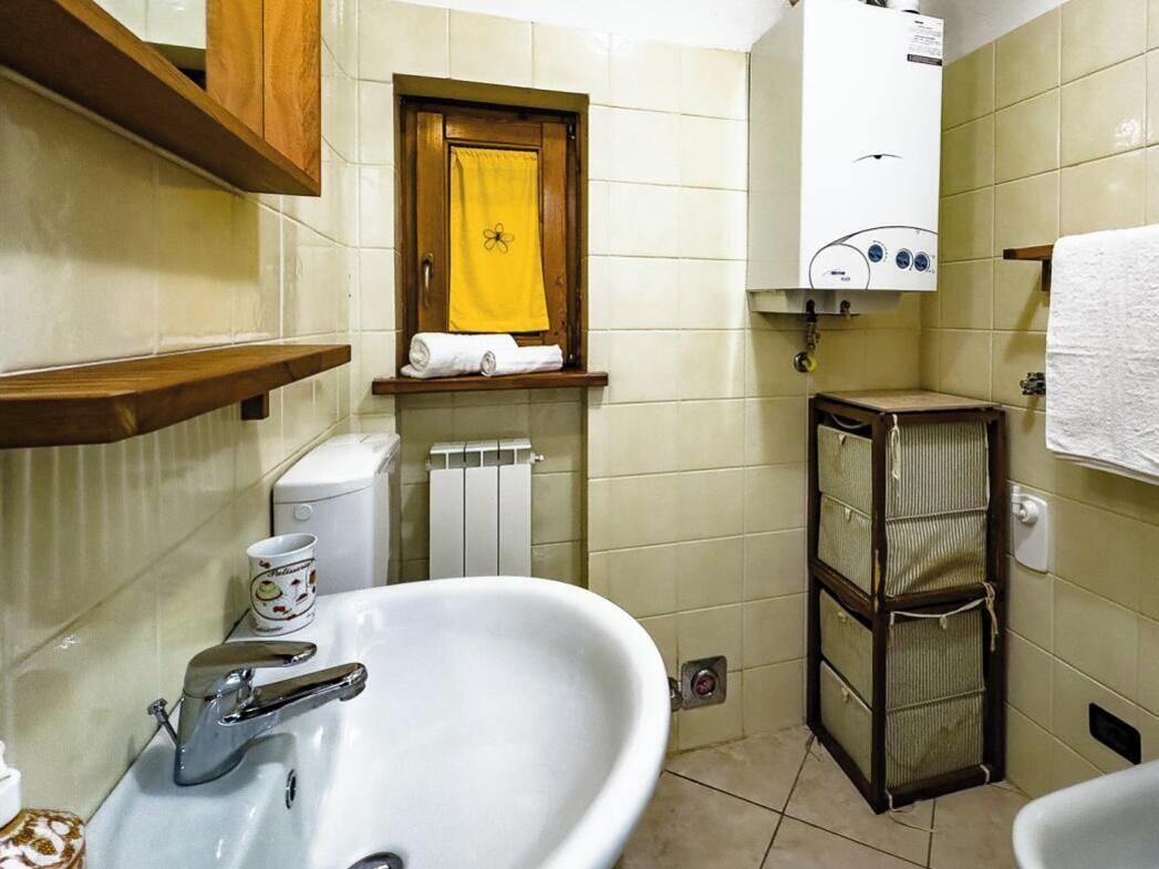 Een badkamer met een wastafel, toilet en handdoekhouder.