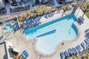 An aerial view of a swimming pool with lounge chairs and a pool deck. - Desert Townhome: Heated Pool & Close to Zion (Washington)
