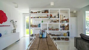 A spacious room with a long wooden table, white walls, and a large window. - Beachfront villa with jacuzzi in Senigallia (Marzocca)
