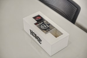 A white box with the word 'HOME' on it, placed on a table.