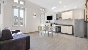A modern kitchen with white cabinets, a built-in oven, and a large window. - Apartment 'Silver' with Wi-Fi and Air Conditioning (Delebio)