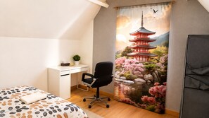 A bedroom with a bed, a desk, a chair, and a large window with a view of a traditional Japanese pagoda.