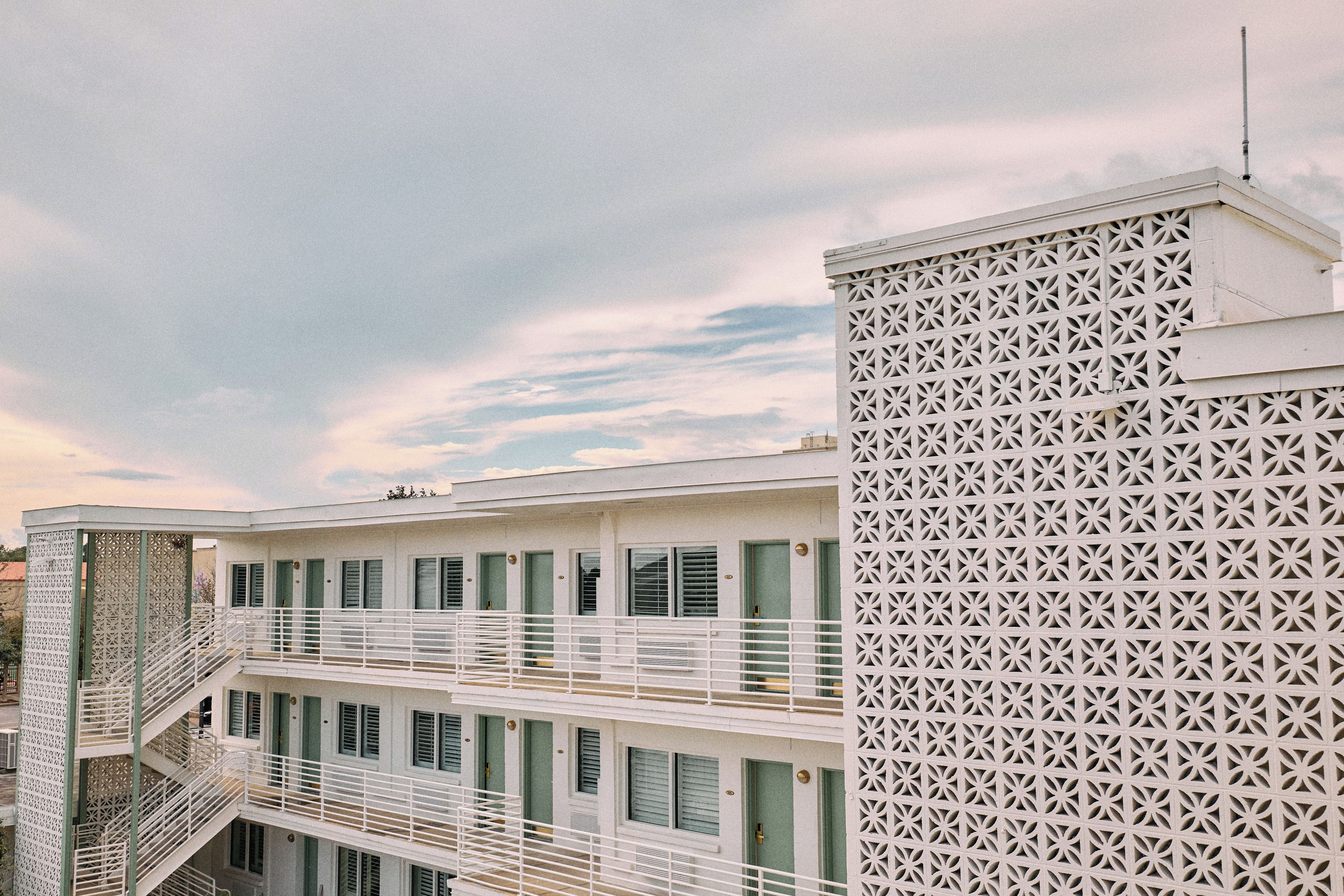 A multi-story building with a balcony and a decorative facade.