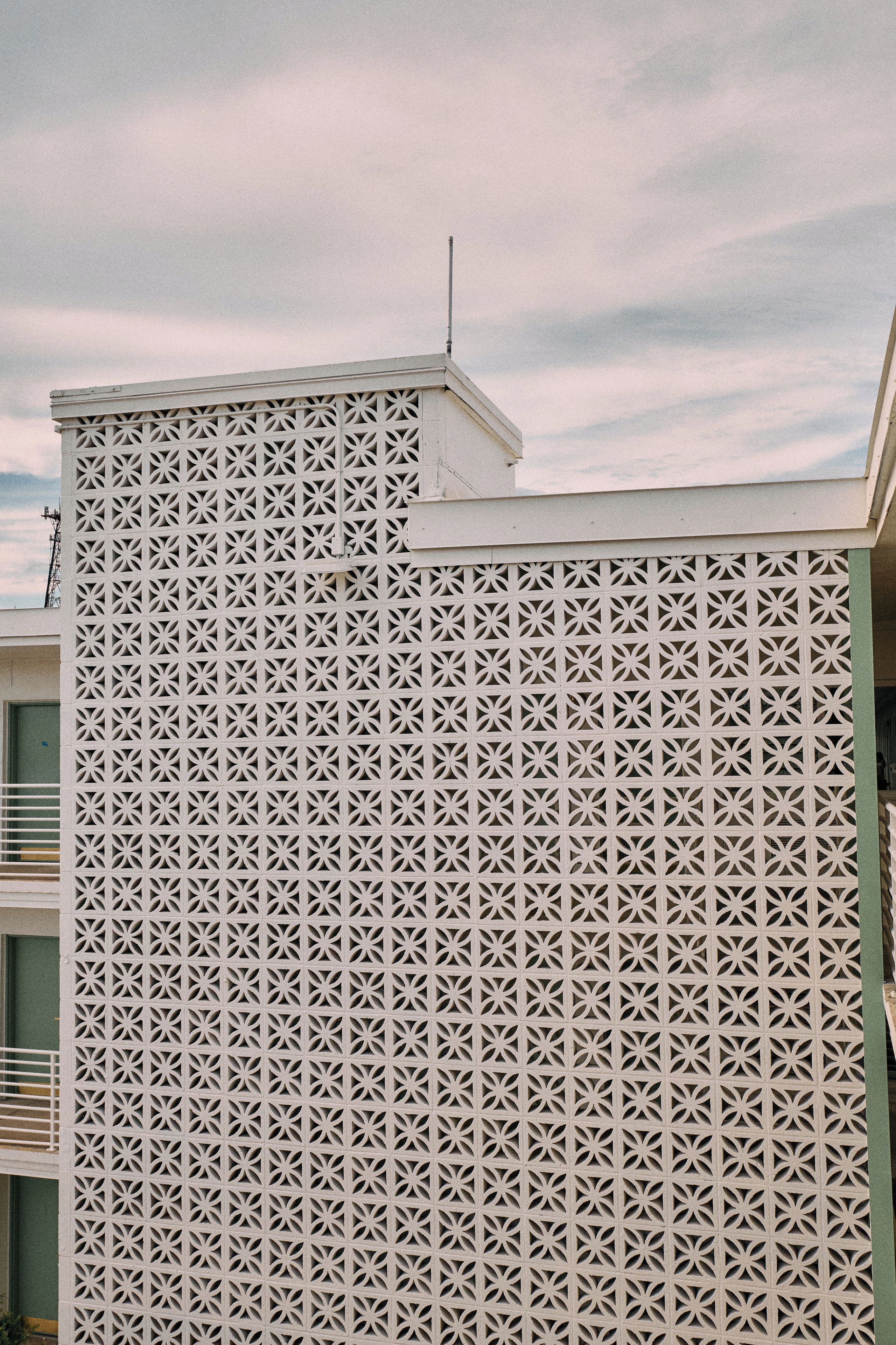 A building facade with a geometric lattice pattern.