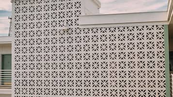 A building facade with a geometric lattice pattern.