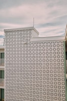 A building facade with a geometric lattice pattern.