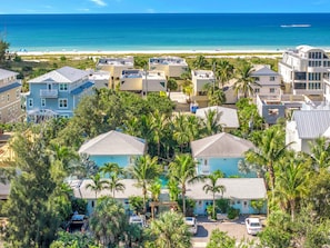 A coastal residential area with houses, a beach, and a clear view of the ocean. - New Listing - Dates Available Now!  Beach & Village | Pool | Dock | Game Room! (Siesta Key)