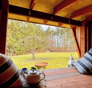 A wooden deck with a table, a teapot, and a lantern. - Idyllic country house overlooking Svanninge Hills (Millinge Faaborg)