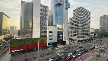 Una calle urbana moderna con edificios altos, incluyendo un banco destacado y edificios de oficinas.
