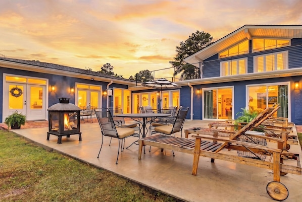 A house with a patio, outdoor seating, and a fire pit.
