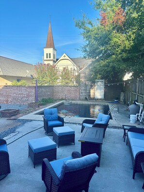 A backyard with a swimming pool, outdoor furniture, and a church steeple in the background. - Main Street House with private pool! (Bay St. Louis)