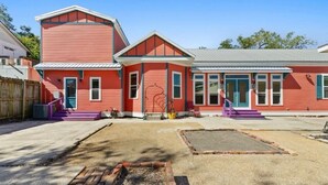 A red building with a porch and a fire pit in the yard. - Main Street House with private pool! (Bay St. Louis)