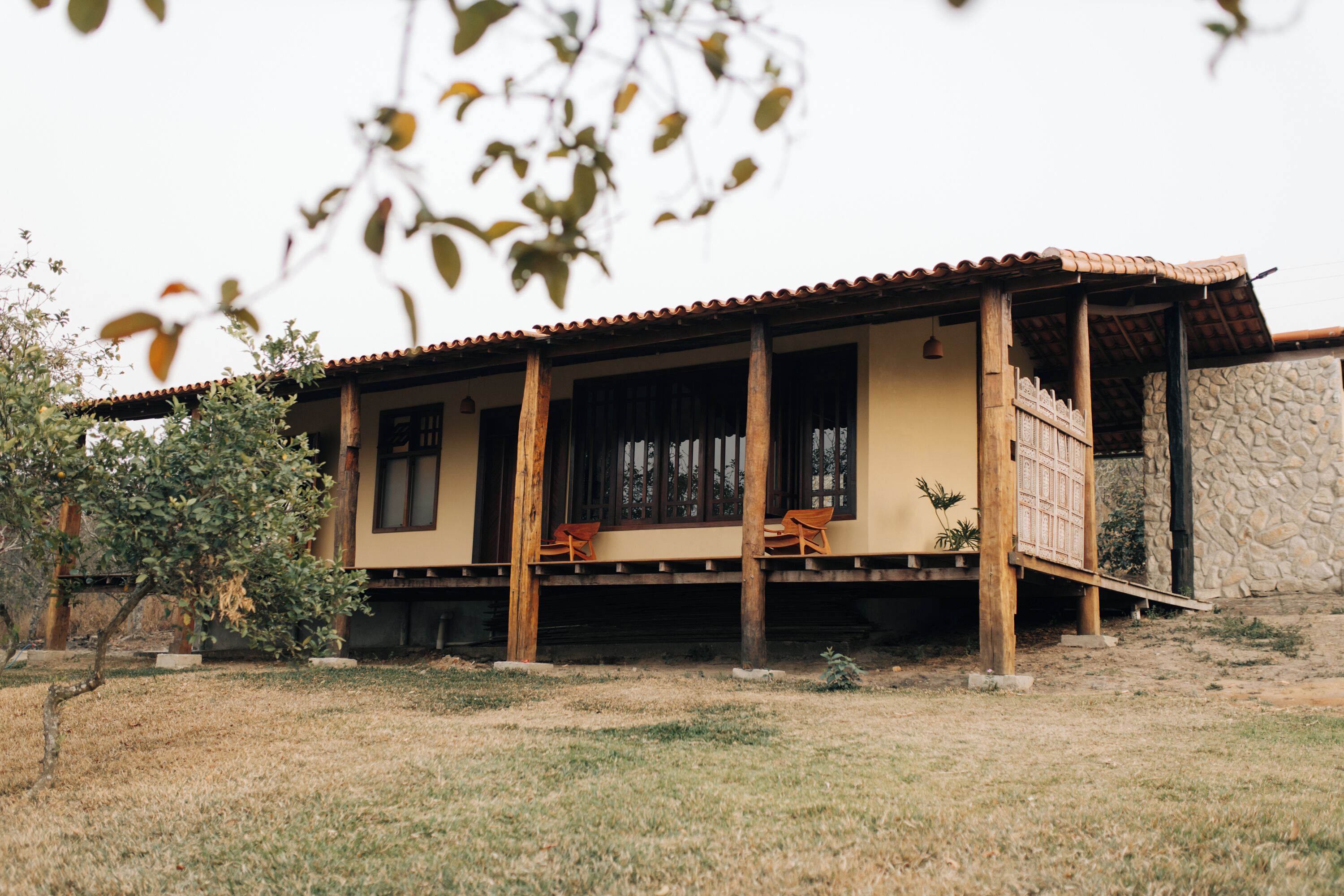 A house with a tiled roof, wooden beams, and a stone wall.