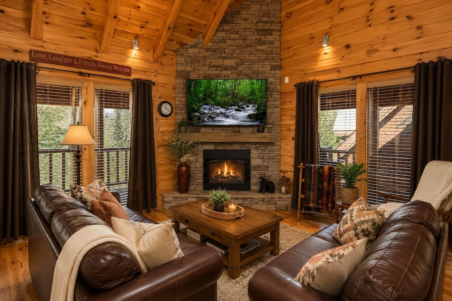 A cozy living room with a fireplace, leather sofas, a coffee table, and a TV mounted above the fireplace.