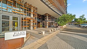 A modern building with a sign for 'Palace Electric.' - Lake View 1-Bed Apartment Canberra Centre (Canberra)
