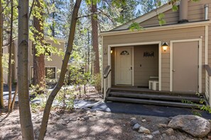 A cabin with a front door, a welcome sign, and a small porch. - Incline Ski & Summer Fun! Walk to Beach, Pool & Hot Tub (Incline Village)