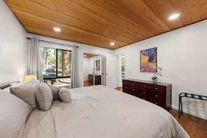 A bedroom with a large bed, a dresser, a nightstand, a window with curtains, and a painting on the wall. - Incline Ski & Summer Fun! Walk to Beach, Pool & Hot Tub (Incline Village)