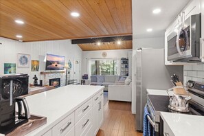 A modern kitchen with a central island, built-in appliances, and a cozy seating area. - Incline Ski & Summer Fun! Walk to Beach, Pool & Hot Tub (Incline Village)
