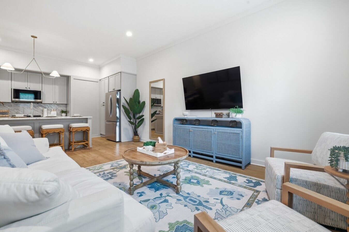 A modern living room with a sofa, coffee table, and blue cabinet.