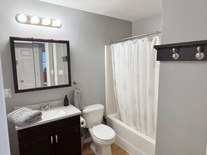 A bathroom with a vanity, toilet, and bathtub. - Close to stadiums and downtown. Pets Welcome: Beautifully remodeled 2 BR Home (Independence)