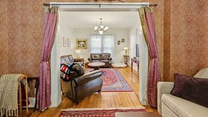 A living room with a leather sofa, a coffee table, and a patterned rug.