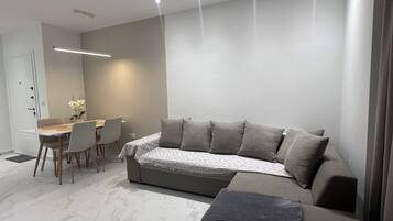 Family Apartment, Balcony | Living area | 100-cm Smart TV with digital channels