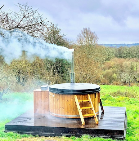 Outdoor spa tub. Stone cottage near Lac de Vassivière