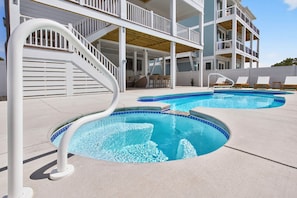 A pool area with two separate pools, a white staircase, and a covered seating area. - Summer Open! 1 Min Walk to Beach, Pool & Spa (Ocean Isle Beach)